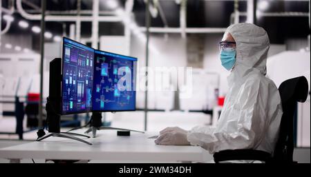 Sterile Semiconductor Manufacturing Factory And Worker In Coverall Stock Photo