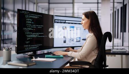 Coder Using Computer At Desk. Web Developer Stock Photo