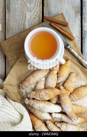 Freshly baked croissants on wooden background Warm Fresh Buttery Croissants and Rolls. homemade baking. Bagels. Cosiness. Stock Photo