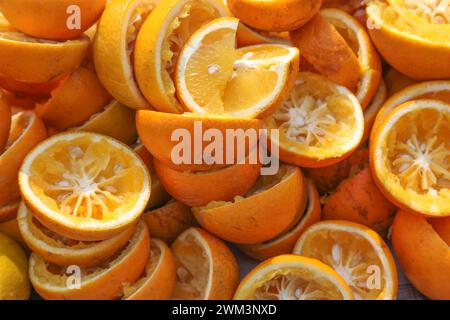 Squeezed orange s leftover from an orange juice making machine. Stock Photo