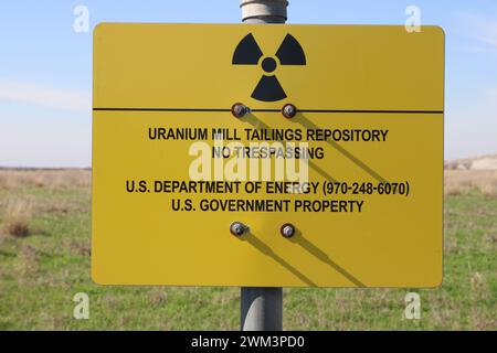 A “Uranium Mill Tailing Repository” and a “Radiation Warning” symbol on a sign along the perimeter fence at the Falls City disposal site near Karnes County, Texas, USA, on February 23, 2024. The Falls City disposal site contains 5.1 million cubic yards of contaminated material, with a total activity of 1,277 curries of radium- 226. The disposal site is located over the Eagle Ford Shale Geological Area, which is an active oil and gas producing region. Recently, the area has had 20 earthquakes of a magnitude 2.5 or or higher in a span of 30 days. (Photo by Carlos Kosienski/Sipa USA) Stock Photo