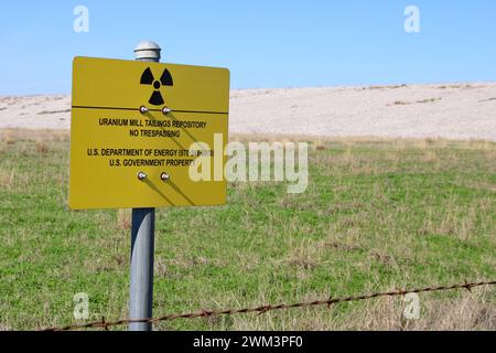 A “Uranium Mill Tailing Repository” and a “Radiation Warning” symbol on a sign along the perimeter fence at the Falls City disposal site near Karnes County, Texas, USA, on February 23, 2024. The Falls City disposal site contains 5.1 million cubic yards of contaminated material, with a total activity of 1,277 curries of radium- 226. The disposal site is located over the Eagle Ford Shale Geological Area, which is an active oil and gas producing region. Recently, the area has had 20 earthquakes of a magnitude 2.5 or or higher in a span of 30 days. (Photo by Carlos Kosienski/Sipa USA) Stock Photo