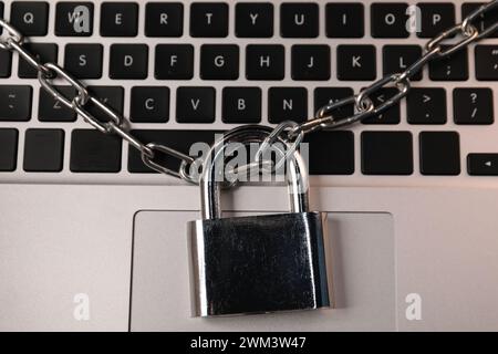 Cyber security. Padlock with chain on laptop, top view Stock Photo