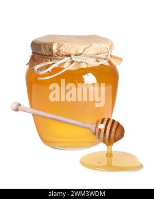 Natural honey dripping from dipper. Jar full of honey on white background Stock Photo