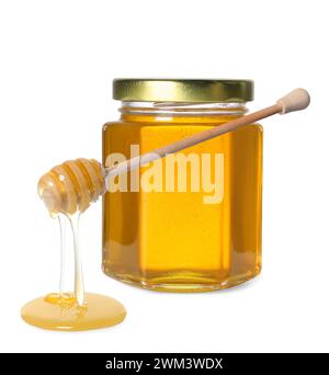 Natural honey dripping from dipper. Jar full of honey on white background Stock Photo