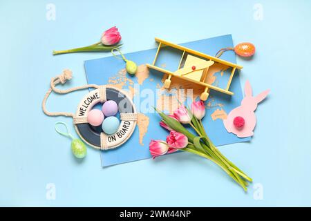 Composition with toy plane, world map, Easter eggs and tulips on color background Stock Photo