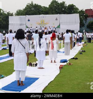 New Delhi, India, June 21, 2023 - Group Yoga exercise session for people at Yamuna Sports Complex in Delhi on International Yoga Day, Big group of adu Stock Photo