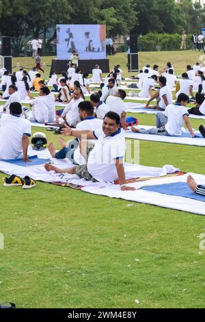 New Delhi, India, June 21, 2023 - Group Yoga exercise session for people at Yamuna Sports Complex in Delhi on International Yoga Day, Big group of adu Stock Photo