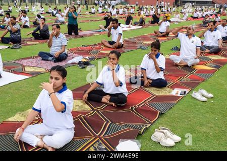 New Delhi, India, June 21, 2023 - Group Yoga exercise session for people at Yamuna Sports Complex in Delhi on International Yoga Day, Big group of adu Stock Photo