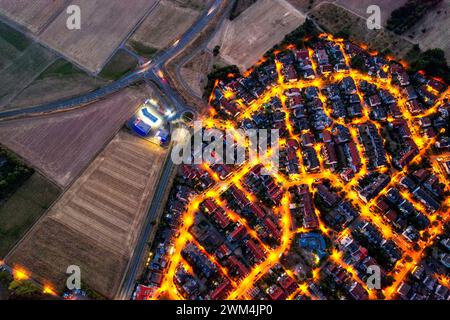 Aerial view of the illuminated streets and residential rooftops of ...
