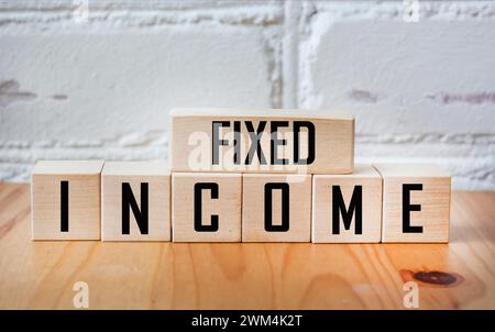 Fixed income symbol. Concept word Fixed Income on wooden blocks. Business and fixed income concept. Copy space Stock Photo