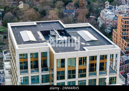 Rotterdam, The Netherlands, February 12, 2024: solar panels and an installation for glass cleaning on the roof of an apartment tower Stock Photo