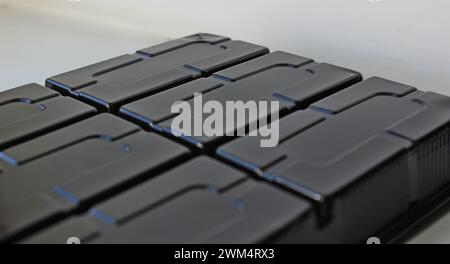 Abstract background of black plastic panel with rectangular slots Stock Photo