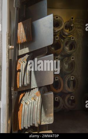 equine farrier or blacksmith supplies various sizes and shapes of metal iron horse shoes as used by equine blacksmith or farrier supply of horseshoes Stock Photo