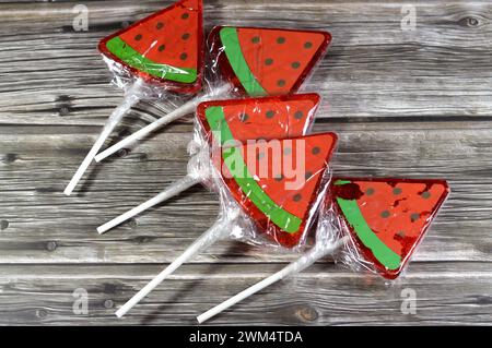 Watermelon flavored lollipop, a type of sugar candy usually consisting of hard candy mounted on a stick and intended for sucking or licking, lolly, su Stock Photo