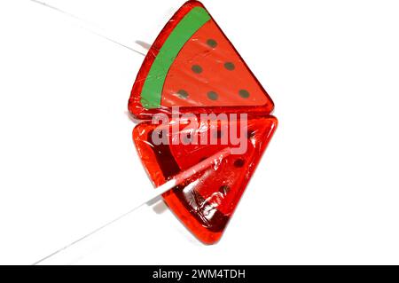 Watermelon flavored lollipop, a type of sugar candy usually consisting of hard candy mounted on a stick and intended for sucking or licking, lolly, su Stock Photo