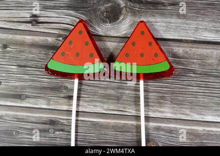 Watermelon flavored lollipop, a type of sugar candy usually consisting of hard candy mounted on a stick and intended for sucking or licking, lolly, su Stock Photo