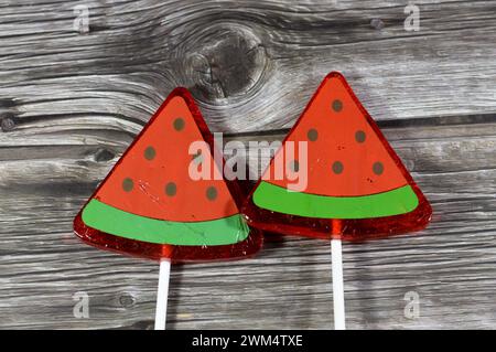 Watermelon flavored lollipop, a type of sugar candy usually consisting of hard candy mounted on a stick and intended for sucking or licking, lolly, su Stock Photo