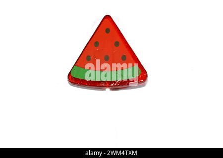 Watermelon flavored lollipop, a type of sugar candy usually consisting of hard candy mounted on a stick and intended for sucking or licking, lolly, su Stock Photo