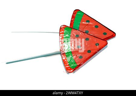 Watermelon flavored lollipop, a type of sugar candy usually consisting of hard candy mounted on a stick and intended for sucking or licking, lolly, su Stock Photo