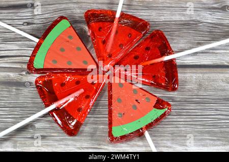 Watermelon flavored lollipop, a type of sugar candy usually consisting of hard candy mounted on a stick and intended for sucking or licking, lolly, su Stock Photo