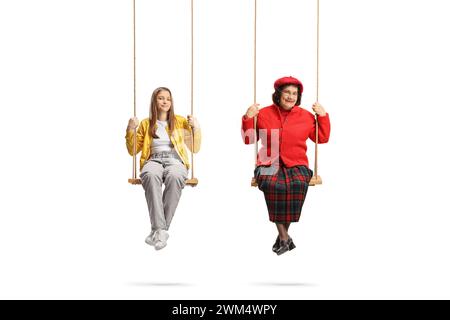 Teenage girl and an elderly lady sitting on wooden swings isolated on white background Stock Photo