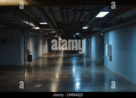 The technical room on the underground floor is illuminated by yellow-blue light bulbs Stock Photo