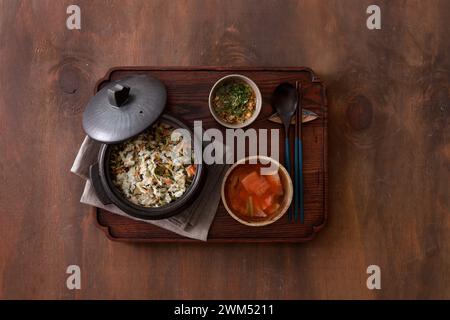 Korean cuisine. Rice with vegetables in a pot on a wooden background Stock Photo