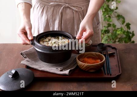 Korean cuisine. Rice with vegetables in a pot on a wooden background Stock Photo