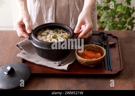 Korean cuisine. Rice with vegetables in a pot on a wooden background Stock Photo