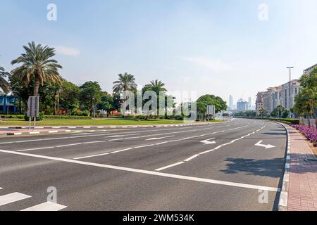Road marking with direction arrow. Empty highway with white painted lines on asphalt and arrows indicating the direction of movement. Stock Photo