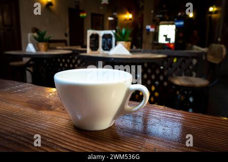 Coffee cup on the table. Cafe. Hot Coffee Cup on Wood Table in blurred Coffee Shop background. Stock Photo