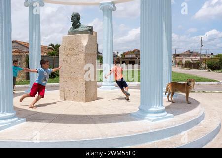 Children playing at the Hemingway monument in Cojimar near Havana. The poet was inspired in the fishing village to his novel 'The old man and the sea' Stock Photo