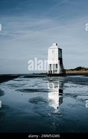Wooden lighthouse on the shoreline Stock Photo