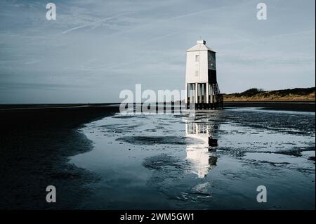 Wooden lighthouse on the shoreline Stock Photo