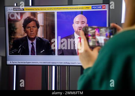 Moscow, Russia. 23rd of February, 2024. Bbroadcast on the information "Russia 24" TV channel of the interview Mike Benz to Tucker Carlson at TV at the exhibition-forum "Russia" at VDNKh in Moscow, Russia Stock Photo