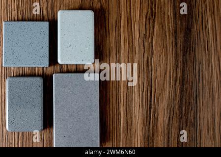 Close up combination of interior material containing set of artficial stone and wooden veneer samples. quartz stone and wooden laminated samples palet Stock Photo