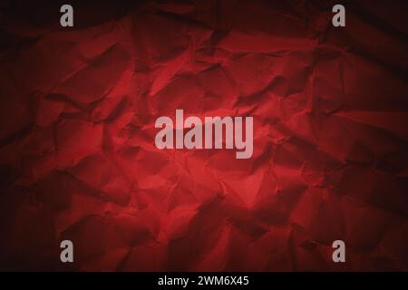 A crumpled crimson paper background. Close up. Stock Photo