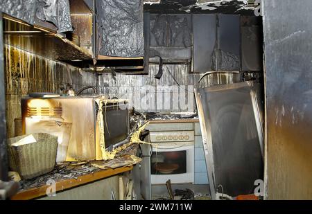 Old oven inside the kitchen consumed by flames in a house. Stock Photo
