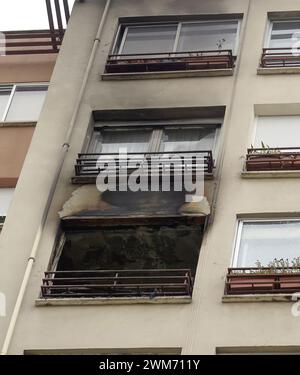 House burned by fire seen from the outside window of a residential building. Stock Photo