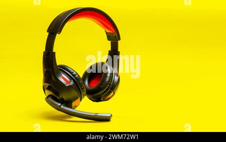 Wireless Over-Ear full size Headphones, Black leather isolated on yellow background Stock Photo