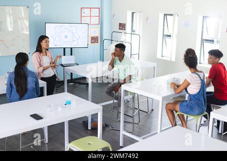 Diverse students engage in a science classroom discussion Stock Photo