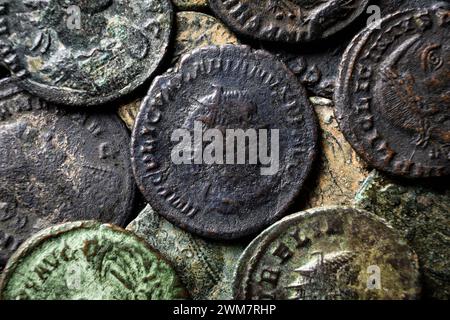 Pile of Ancient Roman coins close-up, pattern of old bronze money with emperors portraits, top view of vintage background. Concept of Rome, Empire, te Stock Photo