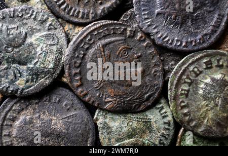 Ancient Roman coins close-up, portrait of emperor Licinius in center, pile of old money, top view of vintage background. Concept of Rome, Empire, text Stock Photo