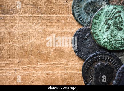 Ancient Roman coins on vintage background, top view, old worn bronze money and copy space close-up. Concept of Rome, Empire, texture, collection, arti Stock Photo