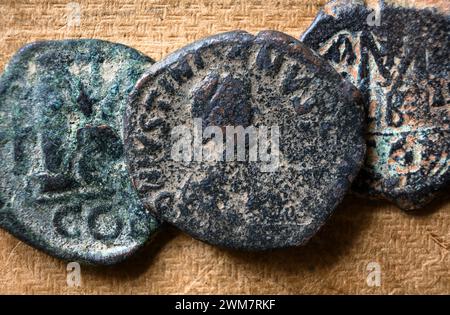 Ancient Byzantine follis coins on vintage background, top view, old worn bronze Roman Greek money close-up. Concept of Rome, Empire, Greece, texture, Stock Photo
