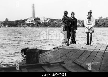 Seminole Indian men standing on a dock across the Jupiter Inlet from the Jupiter Lighthouse in Jupiter, Florida, 1880s. Stock Photo