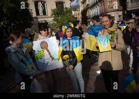Malaga, Spain. 24th Feb, 2024. Protesters are seen holding placards in favor of peace at Plaza de la Constitucion square as they take part in an anti-war protest between Ukraine and Russia. Marking the second anniversary of the Russian invasion of Ukraine, hundreds of people have gathered at Plaza de la Constitucion square in solidarity with Ukraine people, against the war and calling for peace. Credit: SOPA Images Limited/Alamy Live News Stock Photo