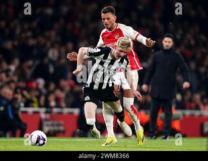 Newcastle United's Anthony Gordon goes down under pressure from Arsenal's Ben White during the Premier League match at the Emirates Stadium, London. Picture date: Saturday February 24, 2024. Stock Photo