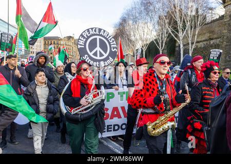 Bradford, UK. 24 FEB, 2024.  The Peace Artistes band play music as the Palestine protest enters central bradford. Credit Milo Chandler/Alamy Live News Stock Photo